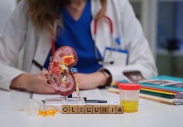 oliguria scritto su legno, dietro, un medico donna